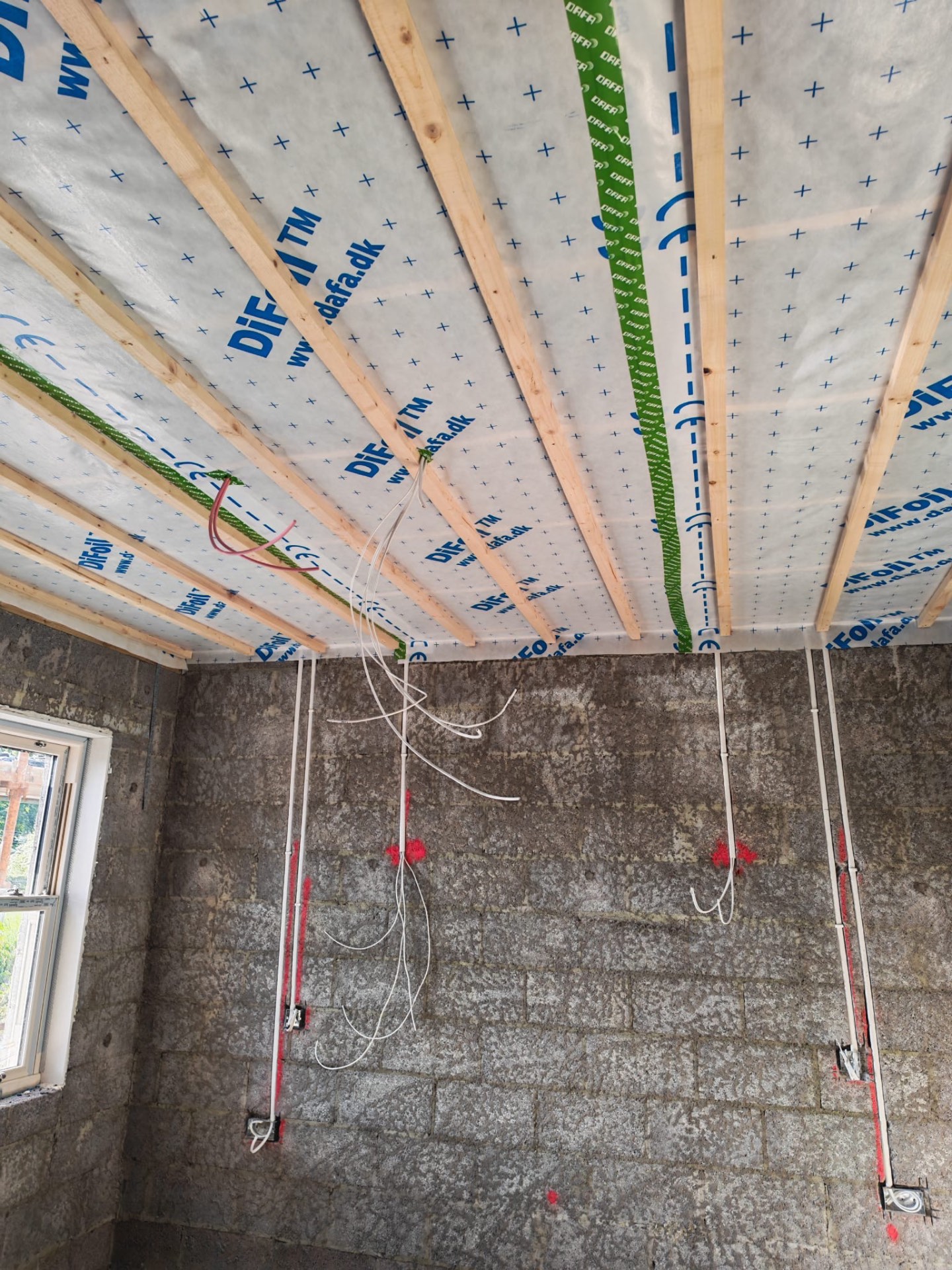 Ceiling before slabbing — exposed timbers and membrane