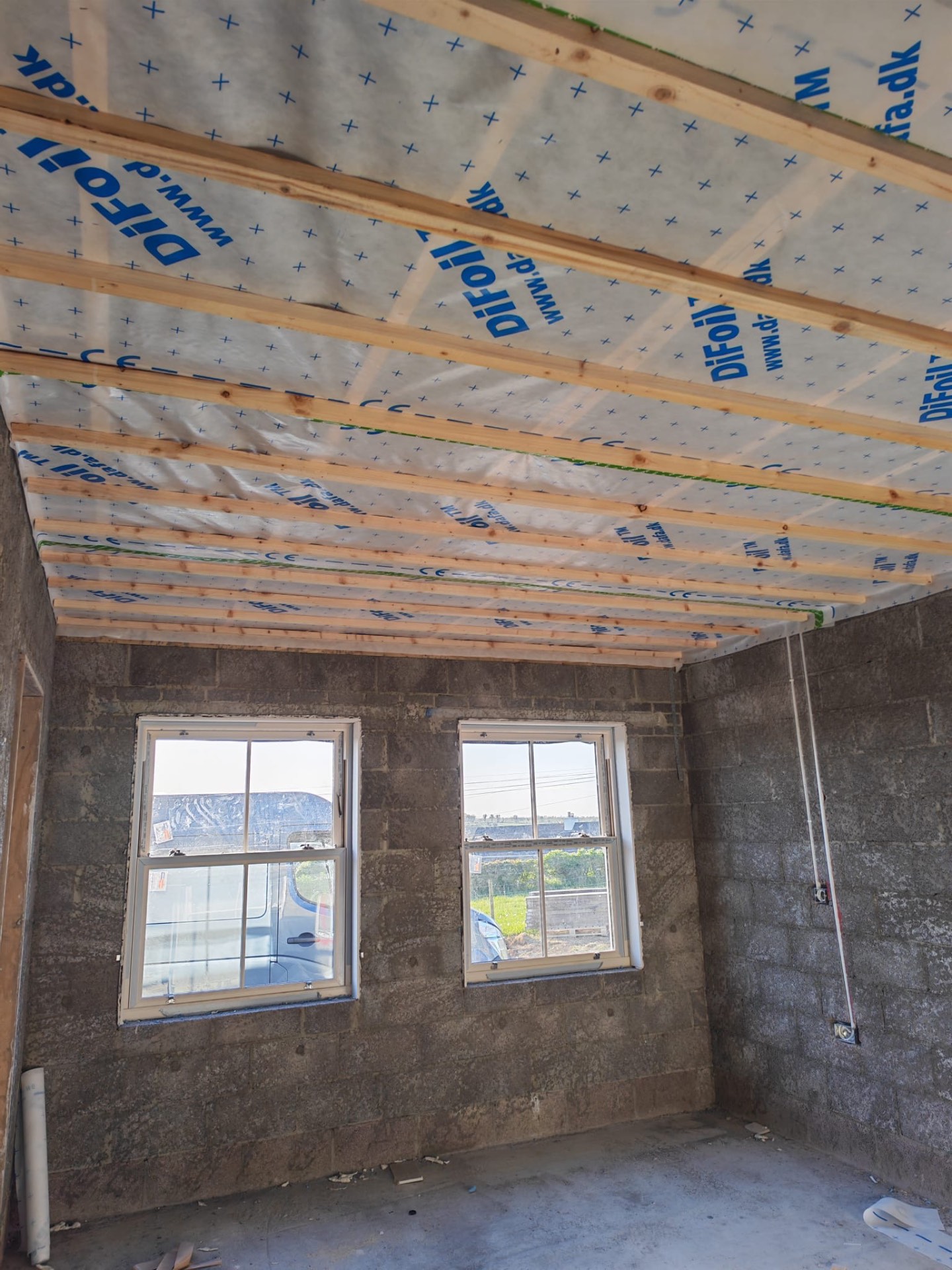 Ceiling before slabbing — exposed timbers and membrane